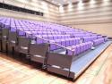 紫色の観覧シートが講堂に向かって並んでいる中央公民館講堂の写真