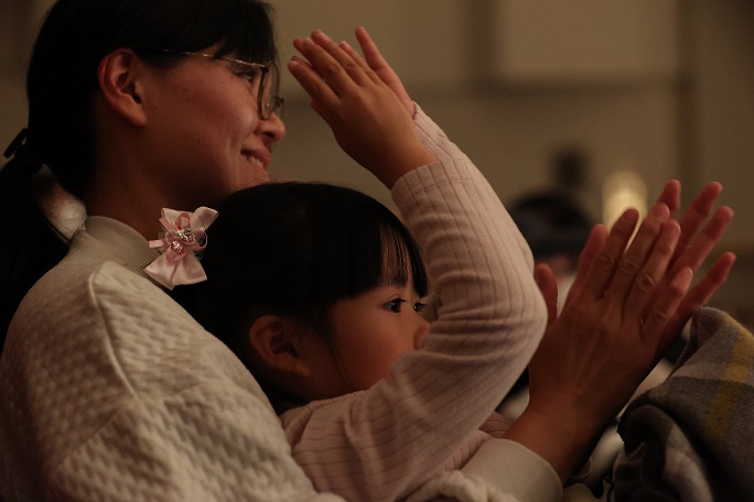 拍手をする来場者の親子