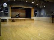 ステージにグランドピアノが用意されている豊春地区公民館講堂の写真